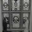 Interior, view of second floor staircase stained glass window with heraldic devices and St Andrew