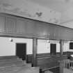 View of balcony and pews underneath balcony from South West