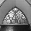 Interior, stained glass above Gothic doorway, detail