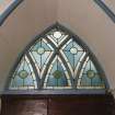 Interior, stained glass above Gothic doorway, detail