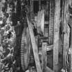 Detailed view of gear drive, connecting peg-drum threshing fixed-barn threshing mill with horse engine (outside, through wall to left)
