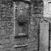 Sacrament house, blocked arched window and grave-slab.