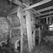 Detail of threshing machine in barn.