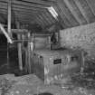 Detail of threshing machine in barn.