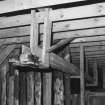 Detail of threshing machine in barn.