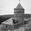 View from N, showing the central tower and wind vane, and its two adjacent 'pavilions'