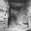 Interior.
View of void above hall gallery showing flagged ceiling and surviving head of original window.