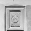 Interior.
Detail of heraldic panel above W window in hall.