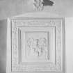 Interior.
Detail of heraldic panel above N window in hall.