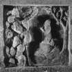 Detail of carved panel on left of well head depicting moses praying and tetragrammaton