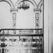 Interior. Landing, showing view of metal balustrade and archways and Raphaelesque paintings, by unknown Italian artists on the walls behind.