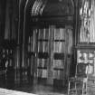 Interior. Round arched double doors flanked by pairs of fluted pilasters.