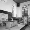 Interior, view of raised platfom from NW with communion table and pulpit