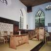 Interior, view of raised platfom from NW with communion table and pulpit