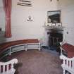 Interior.
View of main hall round tower with fitted seating and fireplace.