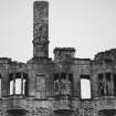 View of upper windows and inscription on South facade of Huntly Castle.