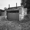 View from NW of building containing sluice mechanism and arch of E bridge, rebuilt to NE of original site (at NJ c. 7783 2041)