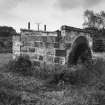 View from SW of building containing sluice mechanism and arch of E bridge, rebuilt to NE of original site (at NJ c. 7783 2041)