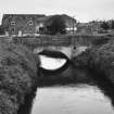 View of W bridge (over canal) from N with mill complex behind