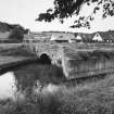 View of W bridge (over canal) from E with mill complex behind