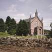 View from W showing church, churchyard and perimeter rubble wall.