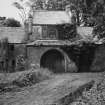 View of coach-house from NW showing central entrance gateway and doocot.