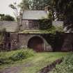 View of coach-house from NW showing central entrance gateway and doocot.