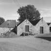 View of SW elevation of mill from SW, also showing kiln on left.