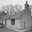 Kirkton of Oyne, township: view of cottage on N side of road (at NJ 6816 2571). Note the chimney pot set in the ridge, suggesting a hanging lum.
