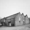 View from NW of Cooperage (L) and two ornate gables of Duty Free Warehouse No.5 (dated 1901)