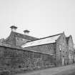 View from NW of main production block of distillery, showing ornate gables of the Tun Room and Mash House, with Malt Bins and Kilns in background, and Still House (R)