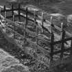 View of mortsafe lying inverted in burial-ground.