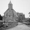 View from West showing gates and graveyard wall.