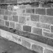 Interior. Detail of main porch stone bench and metal coat rack