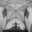 Interior. Detail of crossing showing the rib vault, tower windows and rood figures