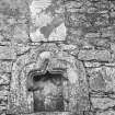 General view of grave-slab and piscina built into North-West wall, North-East of gate.