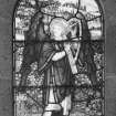Detail of stained glass window depicting an angel playing a small harp
