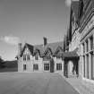 View of South West wing and main entrance porch from East