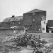 General view from S (harbour side), showing former granary (right) and fish-processing bays (left), which were added in 1896