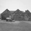 General view from W showing three bays forming fish processing works, the S (right) bay still containing one of four original smoke kilns.  The plaque in the gable of the central bay contains the date 1896, and the initials JSB (John S Boyle), who erected the building during the herring boom