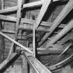 Interior
View of roof space, showing part of vertical line-shaft and flat-belt pulley (with gears above), and adjacent bucket elevators and chute (foreground).