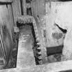 Interior.
View of ground-floor level within gear cupboard, showng water wheel axle and pit wheel (centre).