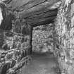 Interior.
Detail of lower level of kiln, showing the slabbed contruction of the invert (above), and the rubble-built firebox (left).