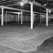 Interior.
View from W in Maltings showing newly laid floor of barley (on ground floor).