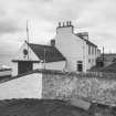 View from E of coastguard station, with houses behind