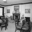 Interior. First floor. Drawing room showing fireplace (dining table and chairs not originally in the room)