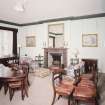 Interior. First floor. Drawing room showing fireplace (dining table and chairs not originally in the room)