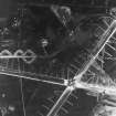 RAF WWII vertical aerial photograph of the main runway crossing point of Dallachy Airfield during the construction phase.  Visible are several anti-landing ditches.