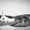 General view from SW of warehouses nos 5 and 7, dam and central buildings of distillery.