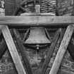 Interior.
View of bell tower showing detail of bell with wheel and timber frame support.